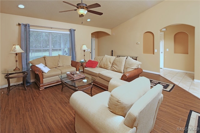 living room featuring hardwood / wood-style floors and ceiling fan