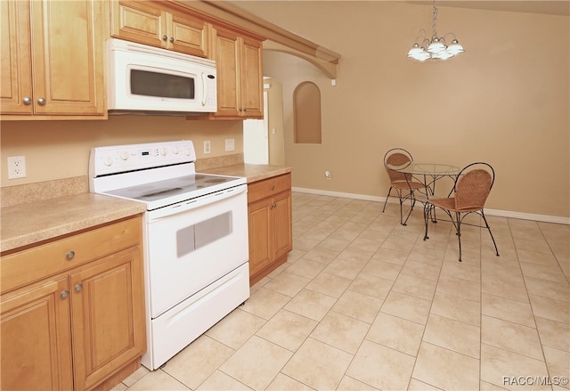 kitchen featuring white appliances, hanging light fixtures, vaulted ceiling, light tile patterned floors, and a chandelier