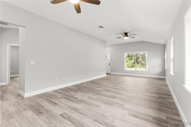 empty room featuring lofted ceiling, ceiling fan, and light hardwood / wood-style flooring