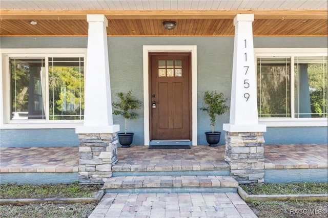 property entrance featuring a porch