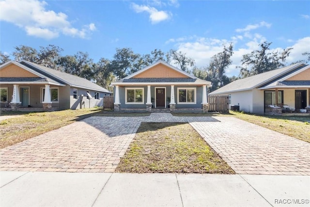 view of front of home with a front yard and covered porch