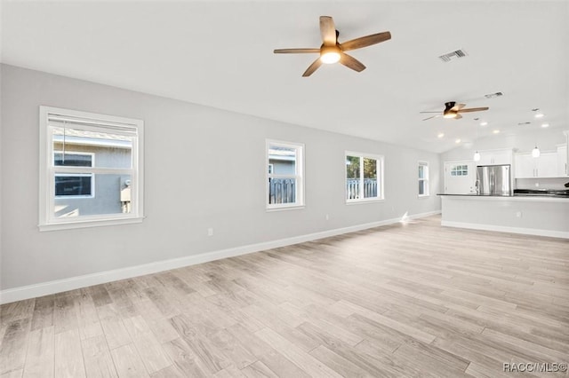 unfurnished living room featuring ceiling fan, lofted ceiling, and light hardwood / wood-style floors