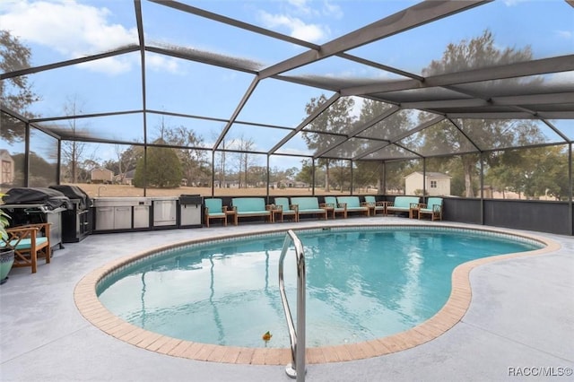 view of pool with exterior kitchen, a patio, a lanai, and a grill