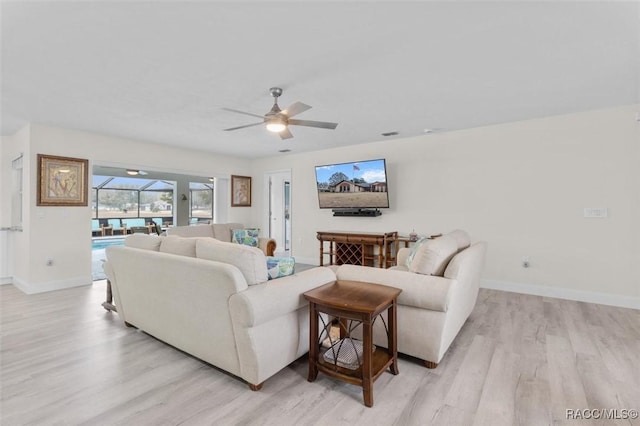 living room with ceiling fan and light wood-type flooring