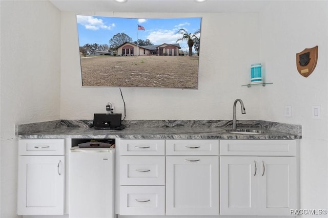 kitchen featuring sink and white cabinets