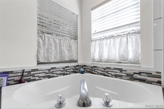 bathroom featuring tiled bath