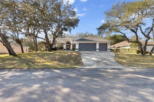 view of front of property featuring a garage and a front lawn