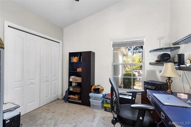 office area with lofted ceiling and light colored carpet