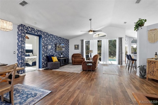 living room with hardwood / wood-style flooring, ceiling fan, and lofted ceiling