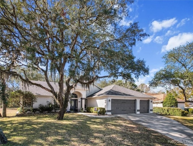 view of front of property with a garage and a front yard