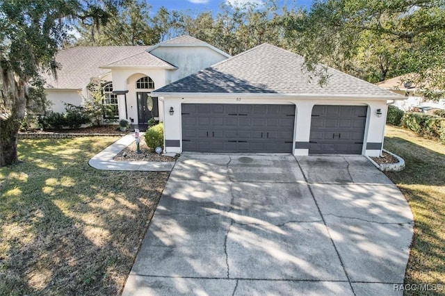 view of front of home featuring a garage and a front yard