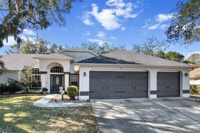 view of front facade with a garage and a front lawn