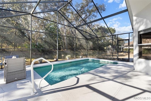 view of swimming pool with a patio and glass enclosure