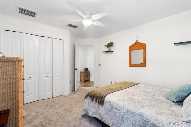 carpeted bedroom featuring a closet and ceiling fan