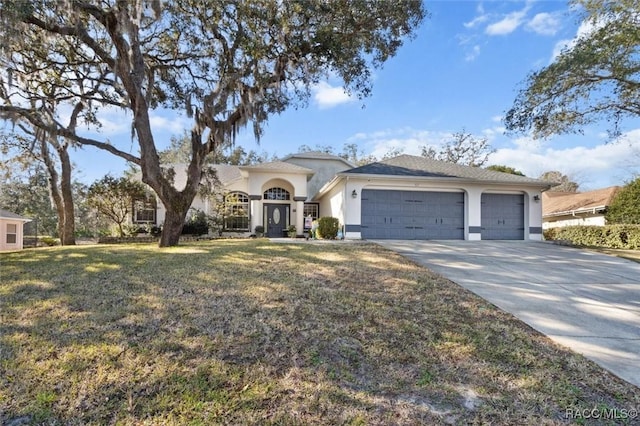 view of front of property with a garage and a front yard