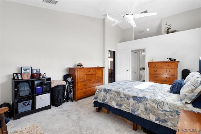 bedroom featuring ceiling fan, high vaulted ceiling, and light carpet