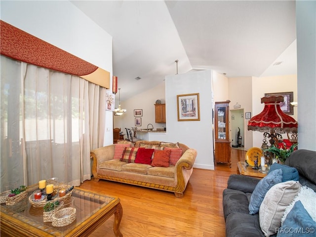 living room featuring light hardwood / wood-style floors and lofted ceiling