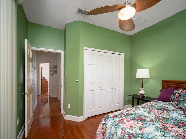 bedroom with ceiling fan, hardwood / wood-style floors, and a closet