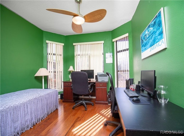 bedroom with ceiling fan and hardwood / wood-style floors