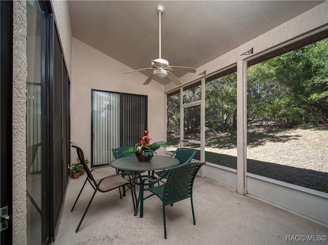 sunroom / solarium featuring ceiling fan and vaulted ceiling