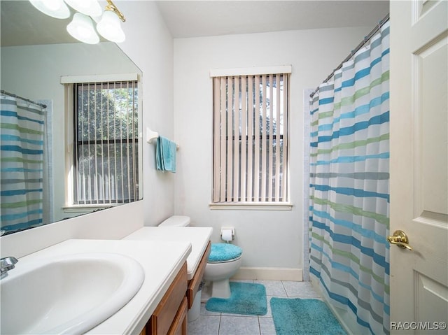 bathroom featuring toilet, vanity, tile patterned floors, and walk in shower