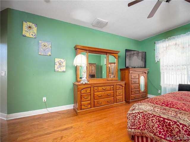 bedroom with ceiling fan and hardwood / wood-style floors