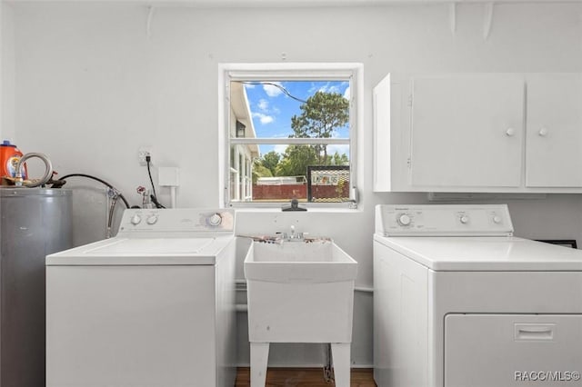33 New York Blvd, Beverly Hills, FL 34465 - laundry area featuring water heater, cabinet space, washing machine and dryer, and wood finished floors