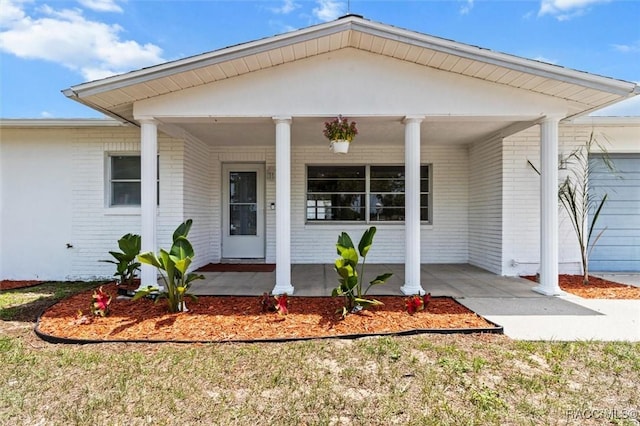 33 New York Blvd, Beverly Hills, FL 34465 - property entrance with brick siding and covered porch