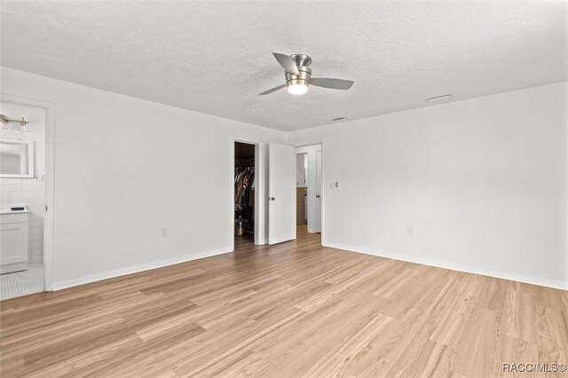 33 New York Blvd, Beverly Hills, FL 34465 - spare room featuring a ceiling fan, light wood-type flooring, and a textured ceiling