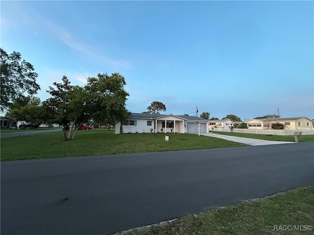 33 New York Blvd, Beverly Hills, FL 34465 - view of front of house featuring driveway, a front lawn, and an attached garage