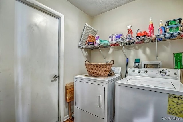 clothes washing area with washer and dryer