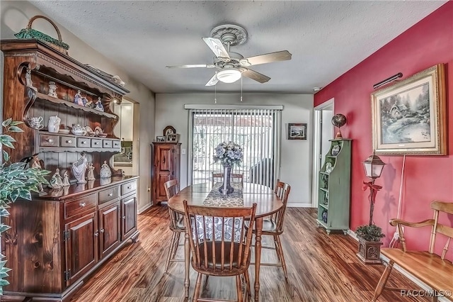 dining area featuring dark hardwood / wood-style floors, ceiling fan, and a textured ceiling