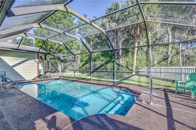 view of swimming pool with a patio and glass enclosure