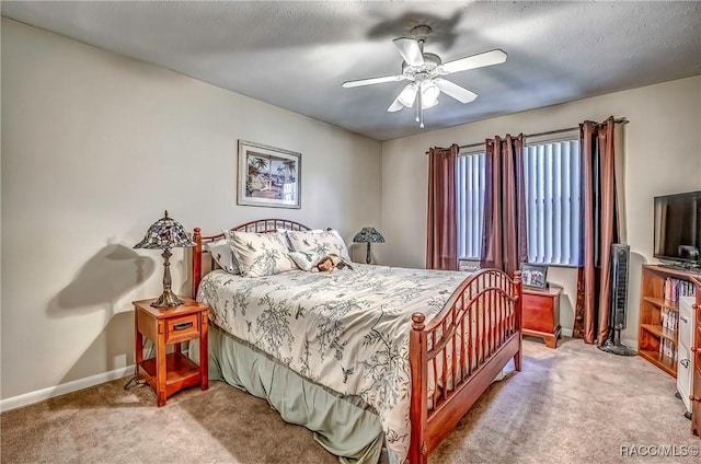 bedroom with carpet flooring, ceiling fan, and a textured ceiling