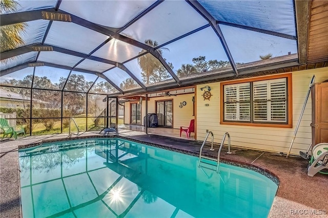 view of pool featuring a patio area, ceiling fan, and a lanai