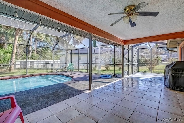 view of swimming pool featuring glass enclosure, a grill, a patio area, and ceiling fan