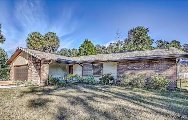 ranch-style home featuring a front yard and a garage