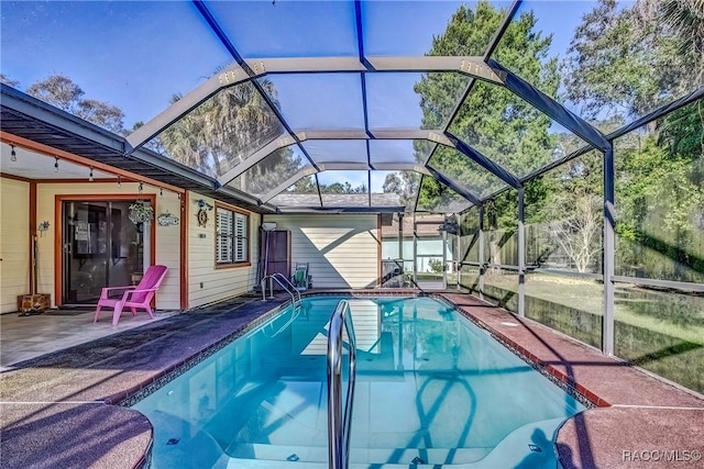 view of pool featuring a patio and glass enclosure