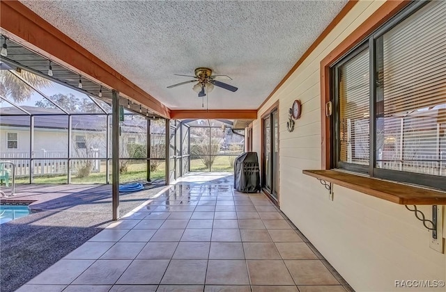 unfurnished sunroom with ceiling fan