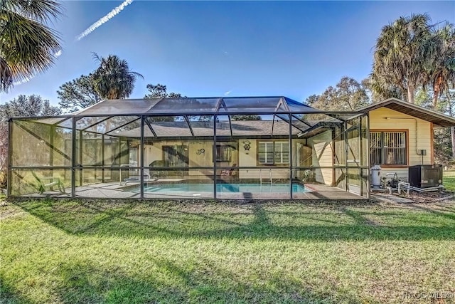 back of house with a lawn, glass enclosure, and central air condition unit