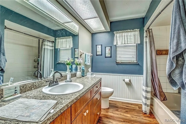 full bathroom featuring shower / bathtub combination with curtain, vanity, toilet, and wood-type flooring