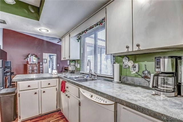 kitchen featuring white dishwasher, white cabinetry, and sink