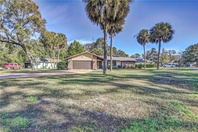 single story home with a front yard and a garage