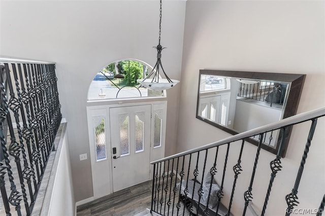 foyer entrance featuring a high ceiling and hardwood / wood-style flooring