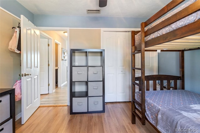 bedroom featuring light hardwood / wood-style floors, a closet, and ceiling fan