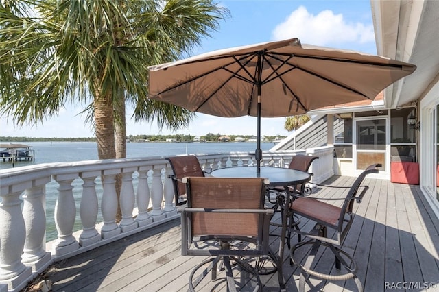 wooden terrace featuring a sunroom and a water view