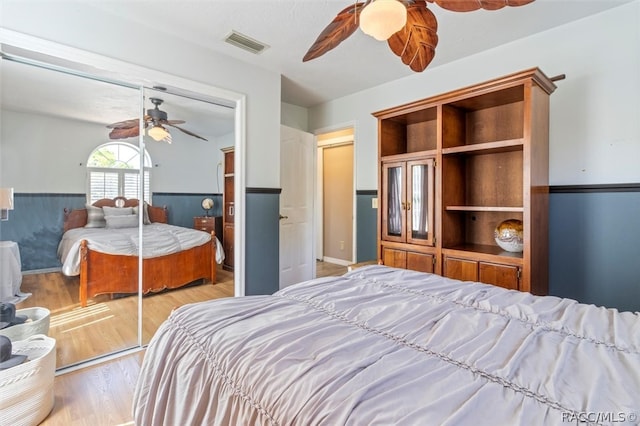 bedroom featuring ceiling fan, a closet, and light wood-type flooring