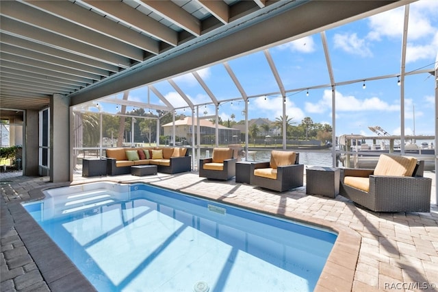 view of swimming pool with an outdoor living space, a patio area, a water view, and glass enclosure