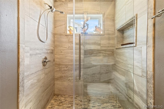 bathroom with tiled shower