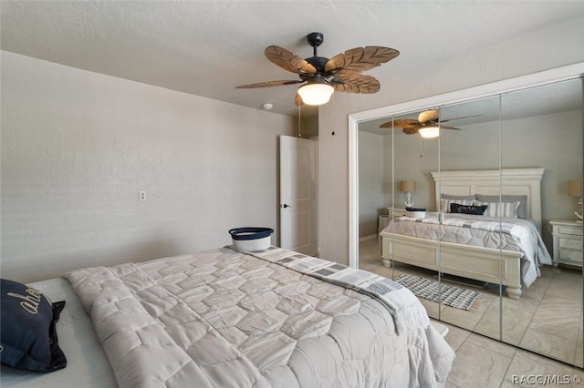 bedroom with ceiling fan and a closet